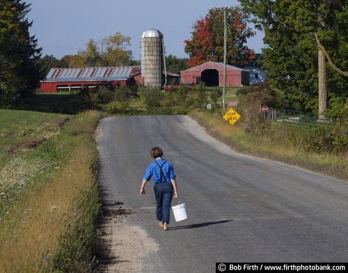 Amish boy, walking to school, country, Wisconsin, WI, farm, agricultural scene, child, barefoot, lunch pail, road,barn
