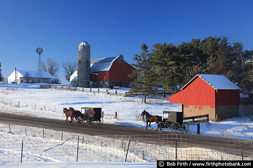 Wisconsin;winter;windmill;WI;road;red barn;horse drawn carriage;homestead;farm;country;carriage;buggy;barn;Amish;agriculture;agricultural scene;field;snow;silo