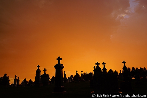 Cemeteries;burial ground;Christian;churchyard;burial;crosses;cross;dead people;graves;gravestones;graveyard;internment of the dead;Minnesota;MN;monuments;New Trier MN;orange sky;sunset;St Marys Catholic Church New Trier MN;rural;tombs;tombstones;approaching storm;dramatic sky;storm clouds