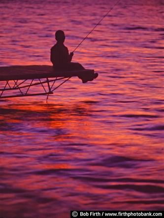 Boy;fishing;Bob Firth;photos;pink sunset;sunset;dock;Croix Firth;Minnesota;lake;child;fishing pole;MN