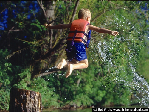 boy;child;jumping;lake;Lake Minnetonka;life jacket;life preserver;life vest;male;Minnesota;MN;playing;airborne;splashing water;stump;summer fun