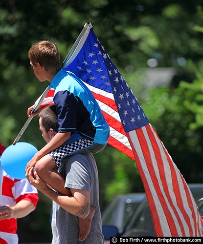 summer;male;friendship;friends;man;Minnesota;kid on Dads shoulders;fun;parade;father and son;child;companion;companionship;Carver County;boy;American flag;Americana;celebration;Chaska MN;patriotic;pride