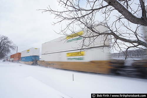 Railroad;industry;train;train cars;transportation;winter;snow on train tracks;snowy tracks;snowy;snow;train in motion;motion;blur;Alma WI;Wisconsin;WI;railcars