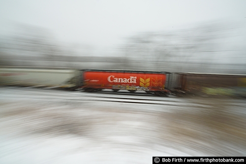 Railroad;industry;train;train cars;transportation;winter;snow on train tracks;snowy tracks;snowy;snow;train in motion;motion;blur;Wisconsin;WI;railcars