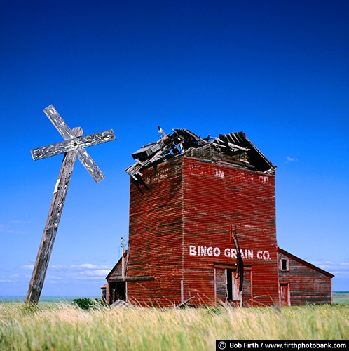 Bingo SD;country;grain elevator;old building;railroad crossing sign;South Dakota;summer;weathering;grasslands;historic;moldering;weathered;rural
