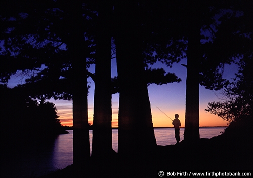 Voyageurs National Park;child;fishing;lake;Minnesota;MN;silhouette;summer;sunset;trees;water;kid;twilight;peaceful;solitude;fishing pole;fun pastime;recreational