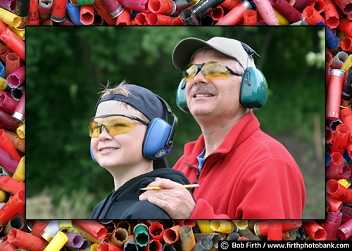 father and son;family activity;eye protection;ear protection;boy;cartridges;child;companion;companionship;friendship;friends;fun pastime;goggles;hearing protection;hunting club;man;male;protective eyewear;recreation;shooting earmuffs;shooting range;shotgun shells;skeet shooting;target practice;teen;teenager;trap shooting