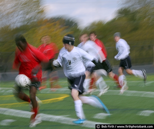 Soccer;futbol;team sport;agressive;determined;hustle;hustling;attacking;persistent;game;boys;teenagers;teens;young men;motion;action;blur;players;running;soccer ball;sport;abstract