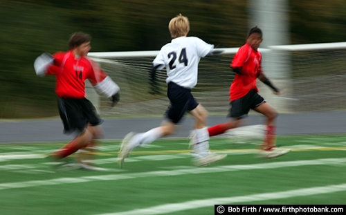 Soccer;futbol;team sport;summer;agressive;hustling;hustle;game;boys;male;teenagers;teens;young men;motion;action;blur;players;running;sport