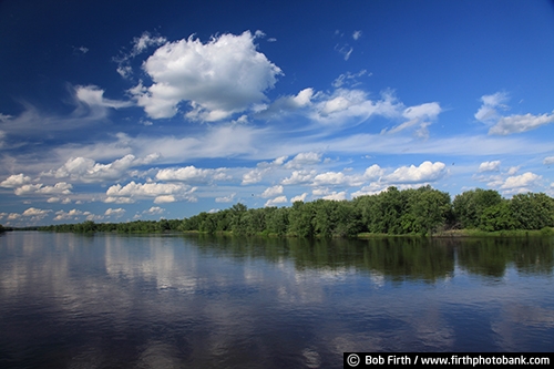 Wisconsin;WI;white puffy clouds;trees;summer;reflections in water;Chippewa River;blue sky