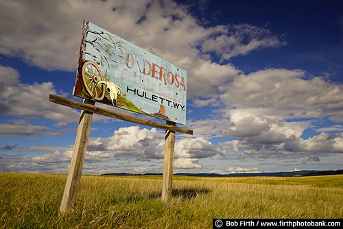 South Dakota;Black Hills;SD;sign;old sign;signage;skull;wagonwheel;wagon wheel;Ponderosa;low angle view;advertising;destination;fading paint;hand painted